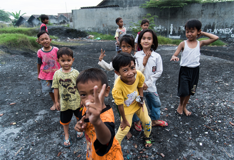 Children playing on a lead waste dump site.