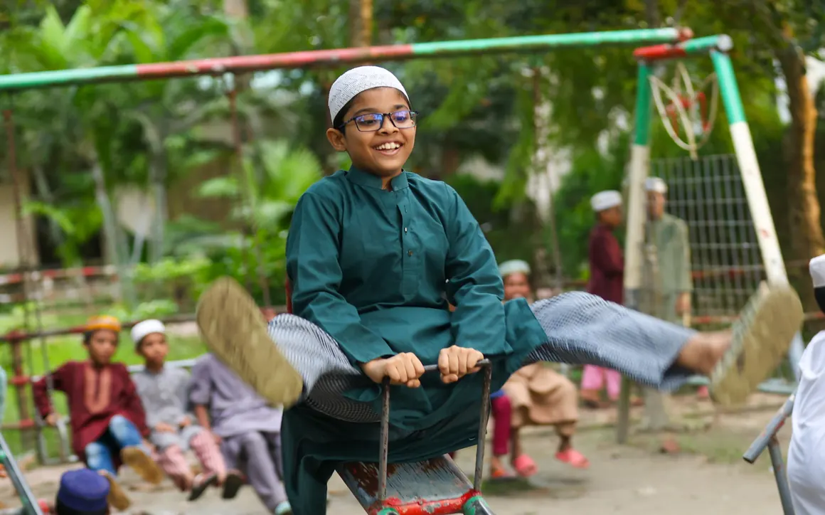 A child plays on a newly remediated playground in Labanchora, Bangladesh, where cleanup cut soil lead levels by more than 99%.