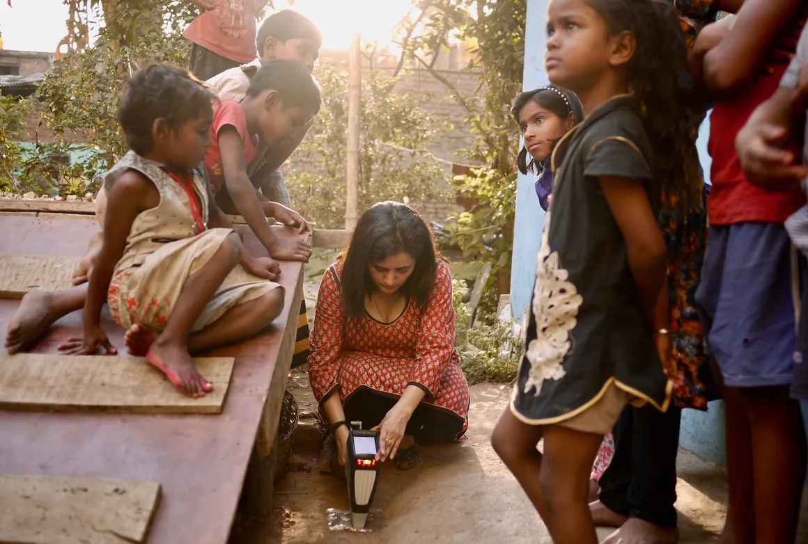 A Pure Earth team member analyzes soil for lead in Karmalichak, India.